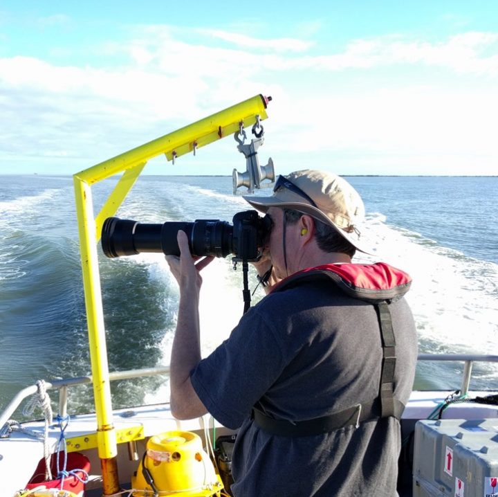 Chris Pelkie photographing birds from the R/V Jaeger 