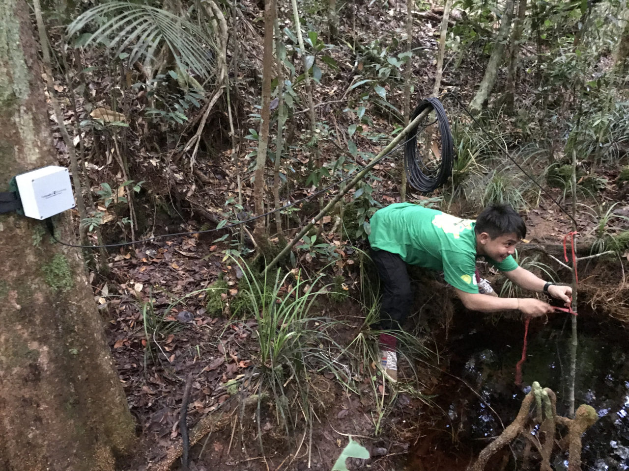 Bioacoustics research staff member, Rido, sets up a SWIFT and hydrophone to record some of Borneo’s freshwater habitats (photo by Wendy Erb)