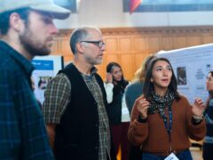Discussion between three people at a workshop