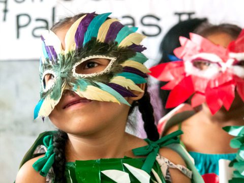 A young girl in a bird mask during the “Celebra las Aves en la Amazonía Peruana” project at a community event in the Peruvian Amazon. Photo by Marilú López-Fretts.