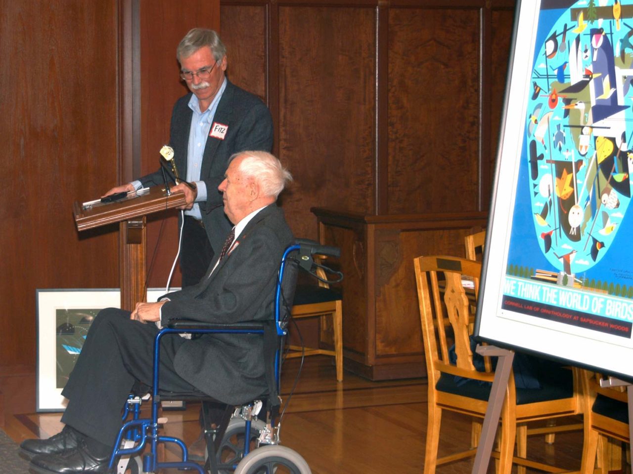 John Fitzpatrick and artist Charley Harper, in wheelchair, next to his artwork