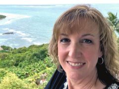 Woman with island beach in background.