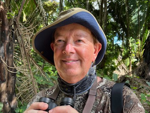 a man holding binoculars
