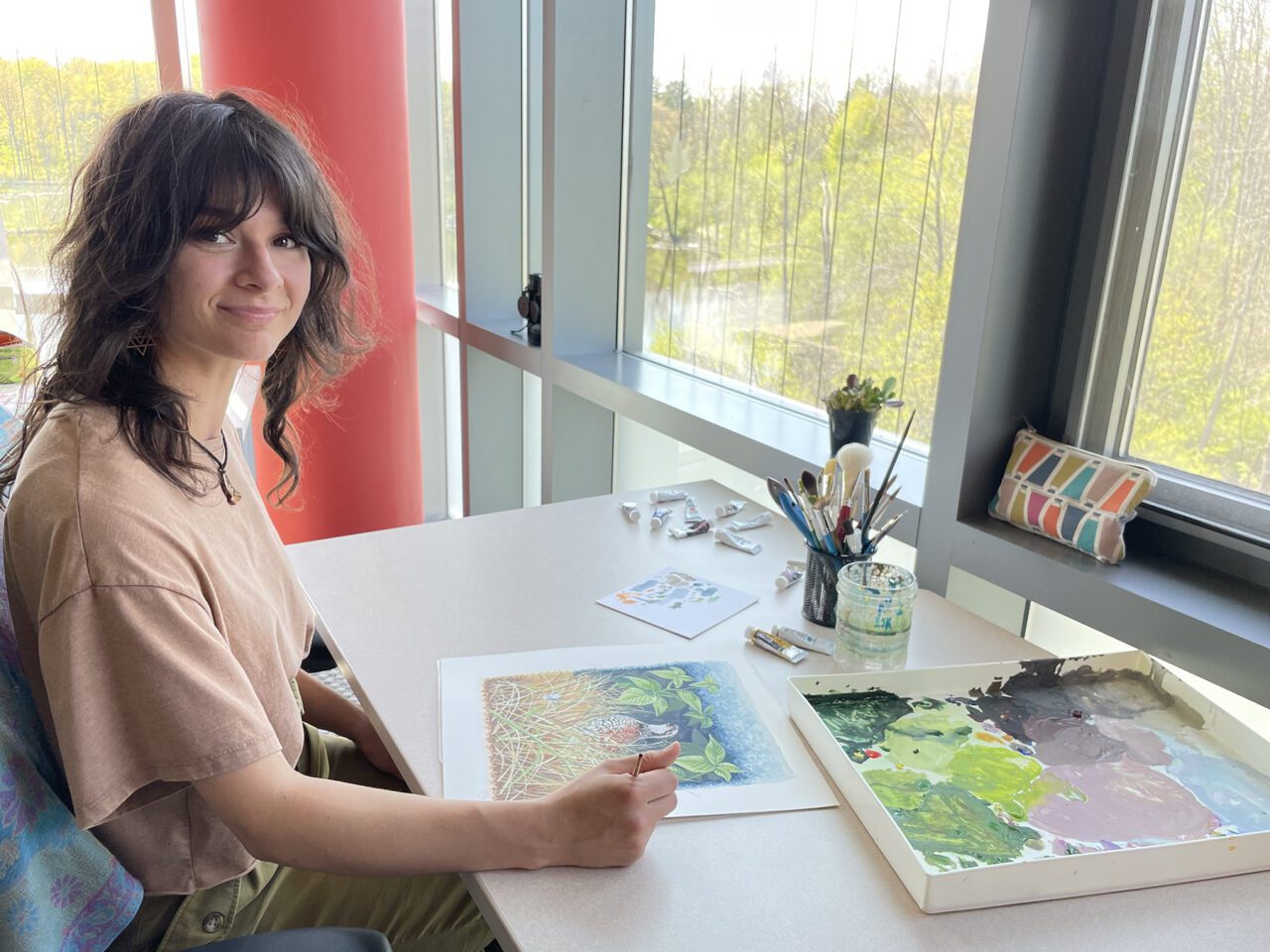 Maria painting at desk