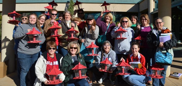 Educators holding bird feeders after receiving them from an Ambassador workshop.