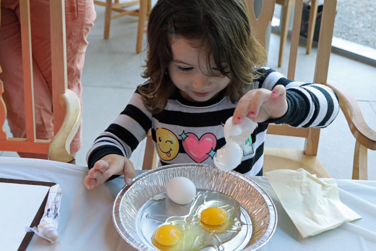 Girl cracking an egg