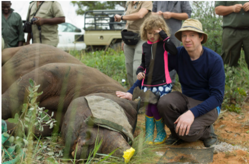 Image of Dr. Radcliffe with a rhino.