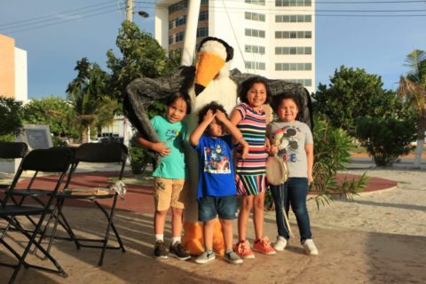 Four kids pose in front of person dressed as a Least Tern