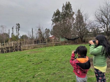 Two girls birdwatching with binoculars