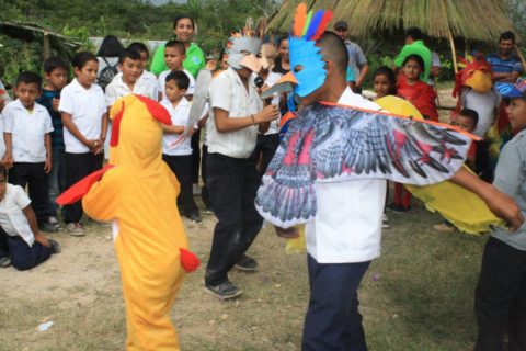 A group of youth perform in bird costumes