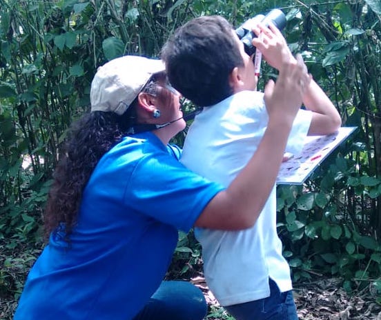 A woman and a youth birdwatching