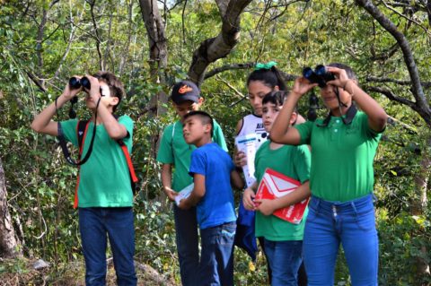 A group of youth with binoculars.
