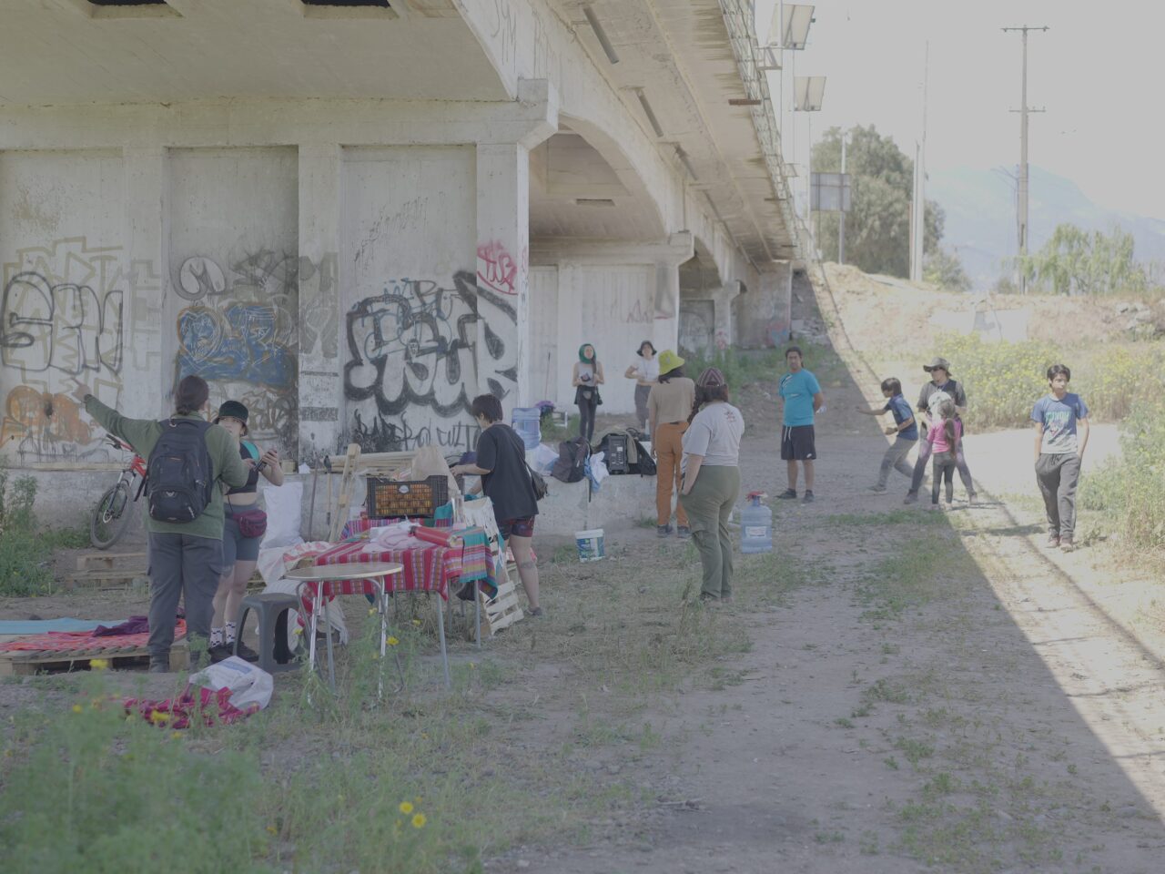 A group of people standing under a bridge