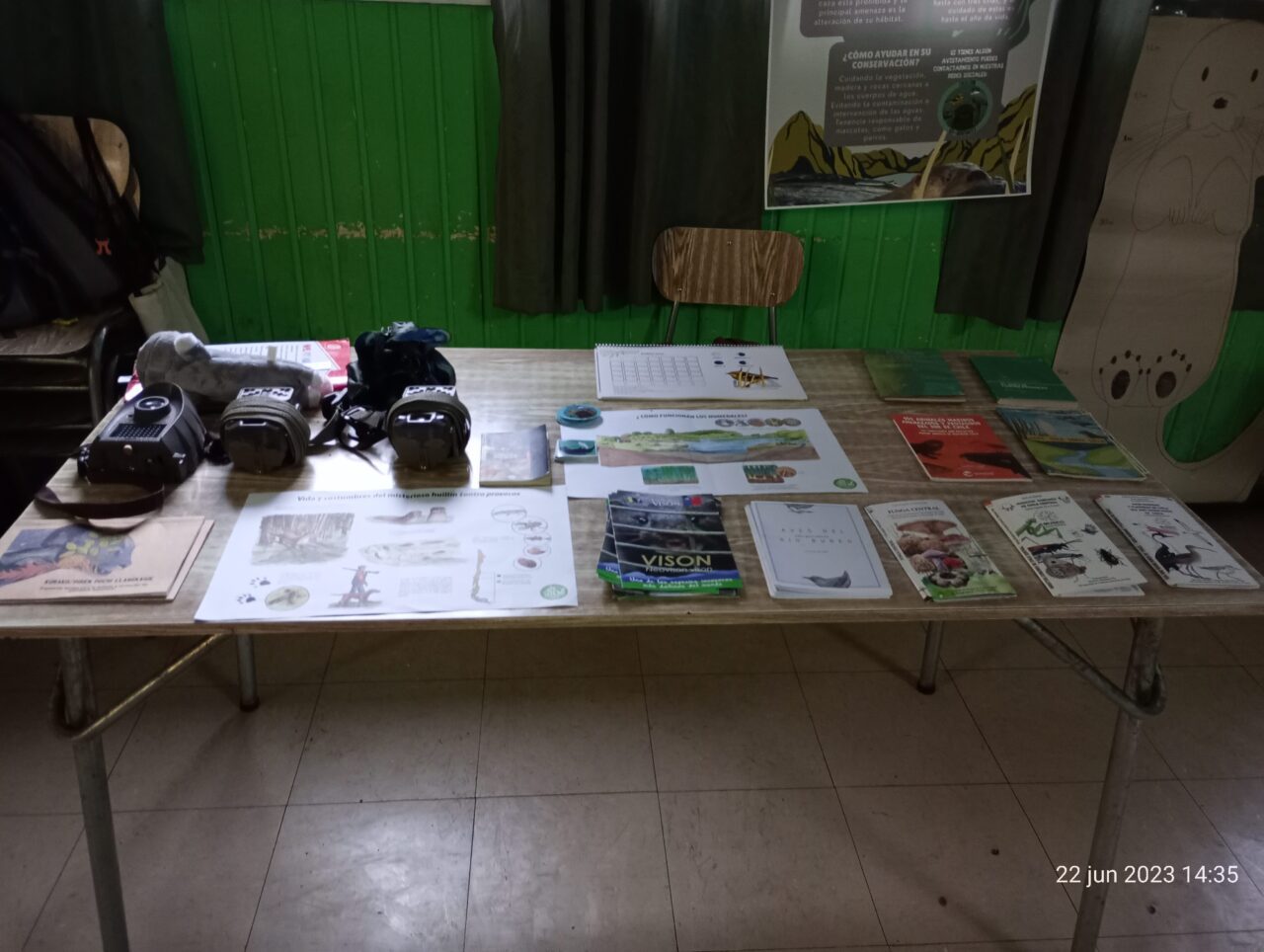 Table with activity sheets, bird guides, and birding equipment.