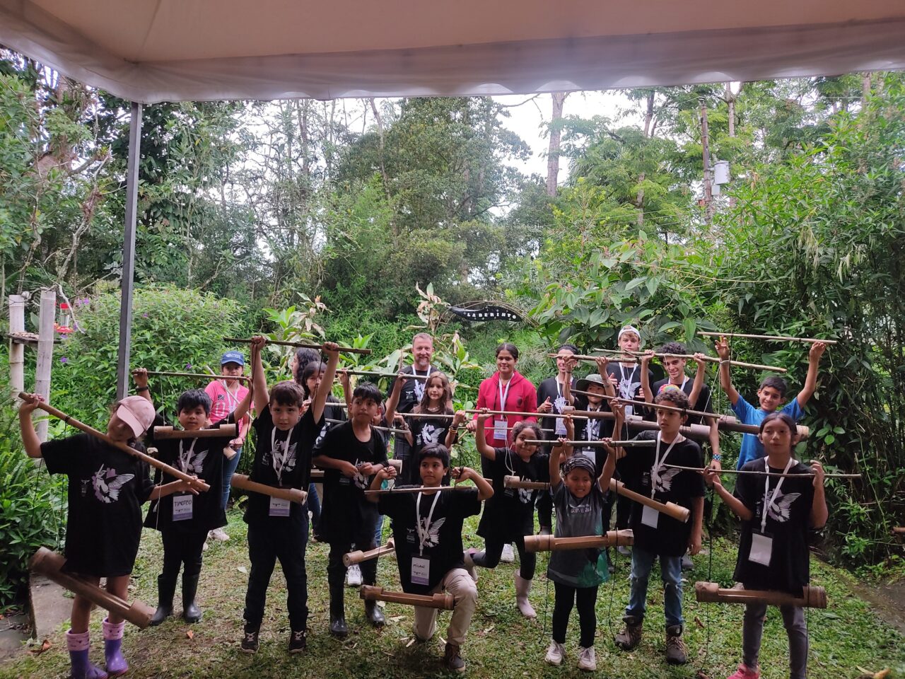 Kids holding up handmade bird feeders
